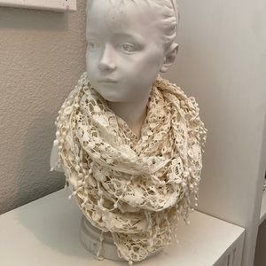 Beautiful cream, lace infiniti loop scarf with fun fringe accents.